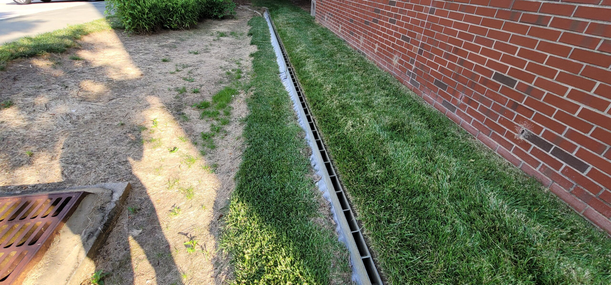 Level spreader dispersing stormwater evenly across a vegetated area