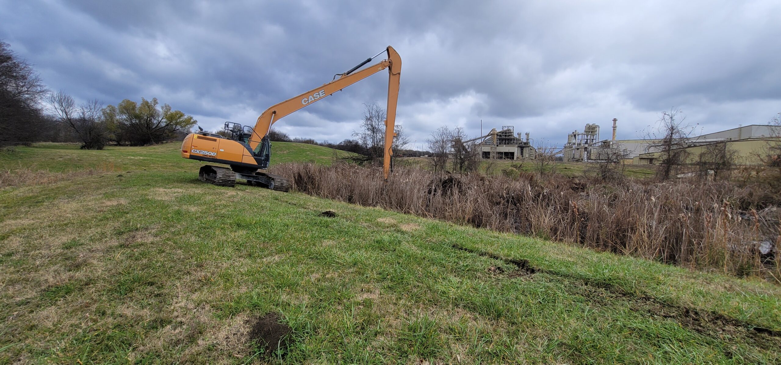 Mechanical dredging of stormwater detention pond to remove sediment and restore storage capacity