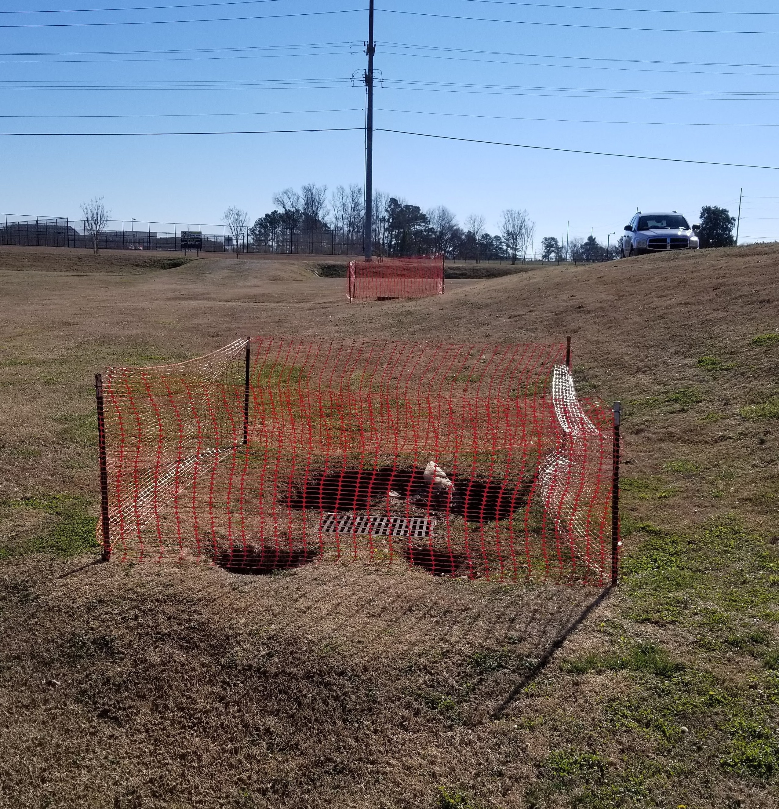 Neglected stormwater control measure showing holes near stormwater assets