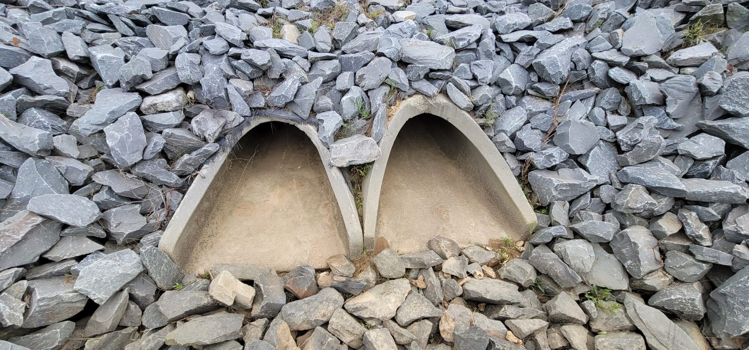 Stormwater inlet with riprap apron and sediment forebay designed to prevent sediment from entering downstream systems.
