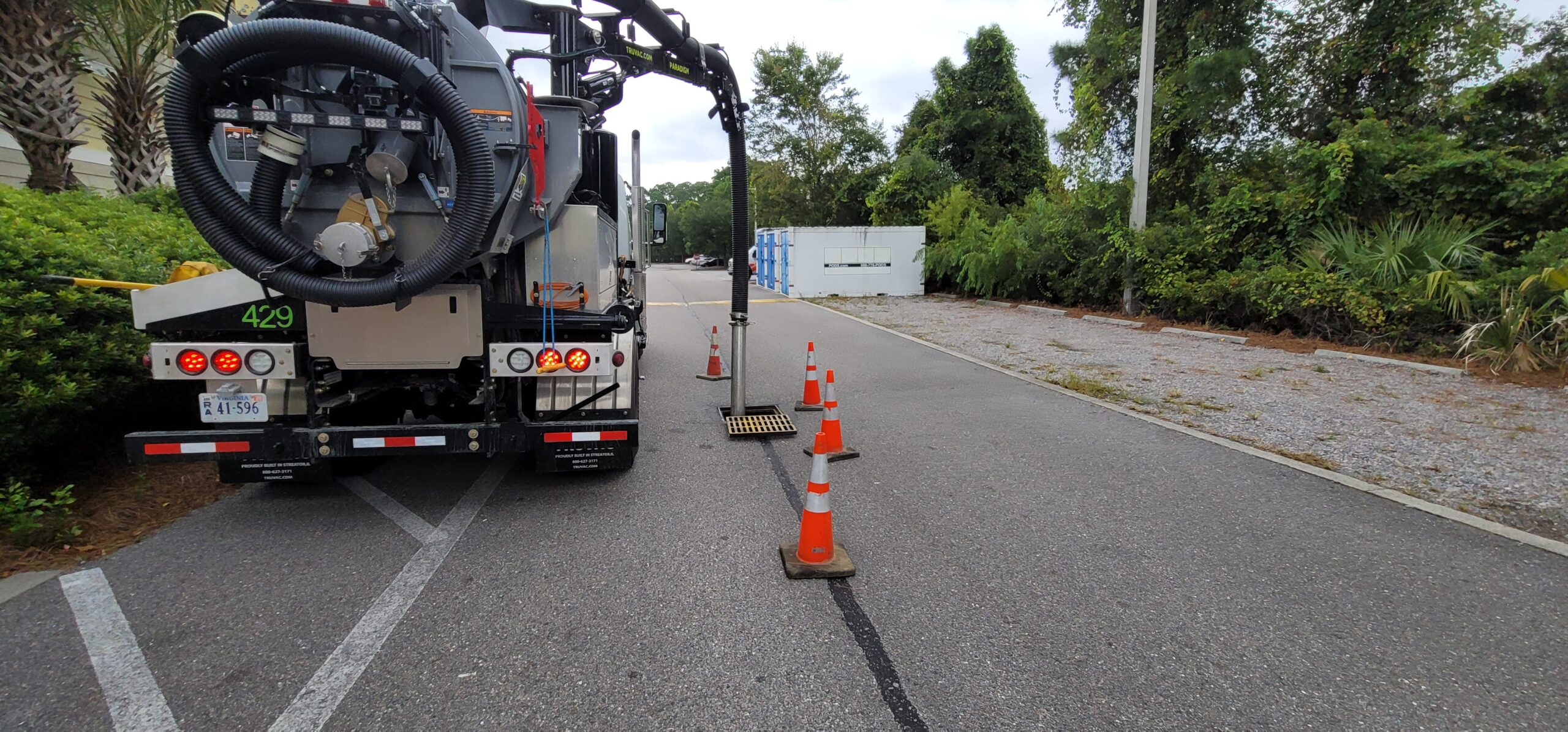 Vactor truck removing debris and sediment from stormwater catch basin to prevent blockages.
