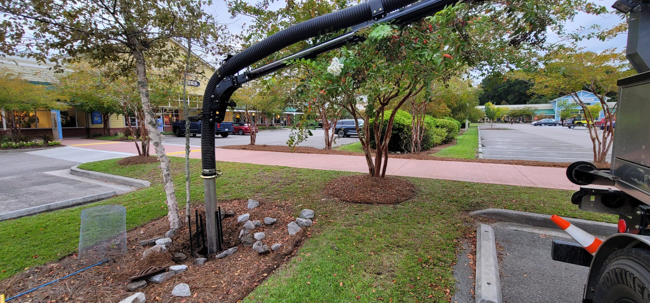 Hydro excavation equipment safely exposing underground stormwater utilities