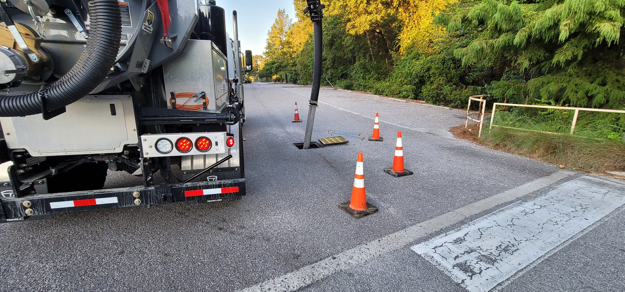 Vactor truck performing vacuum excavation and debris removal from storm drain system