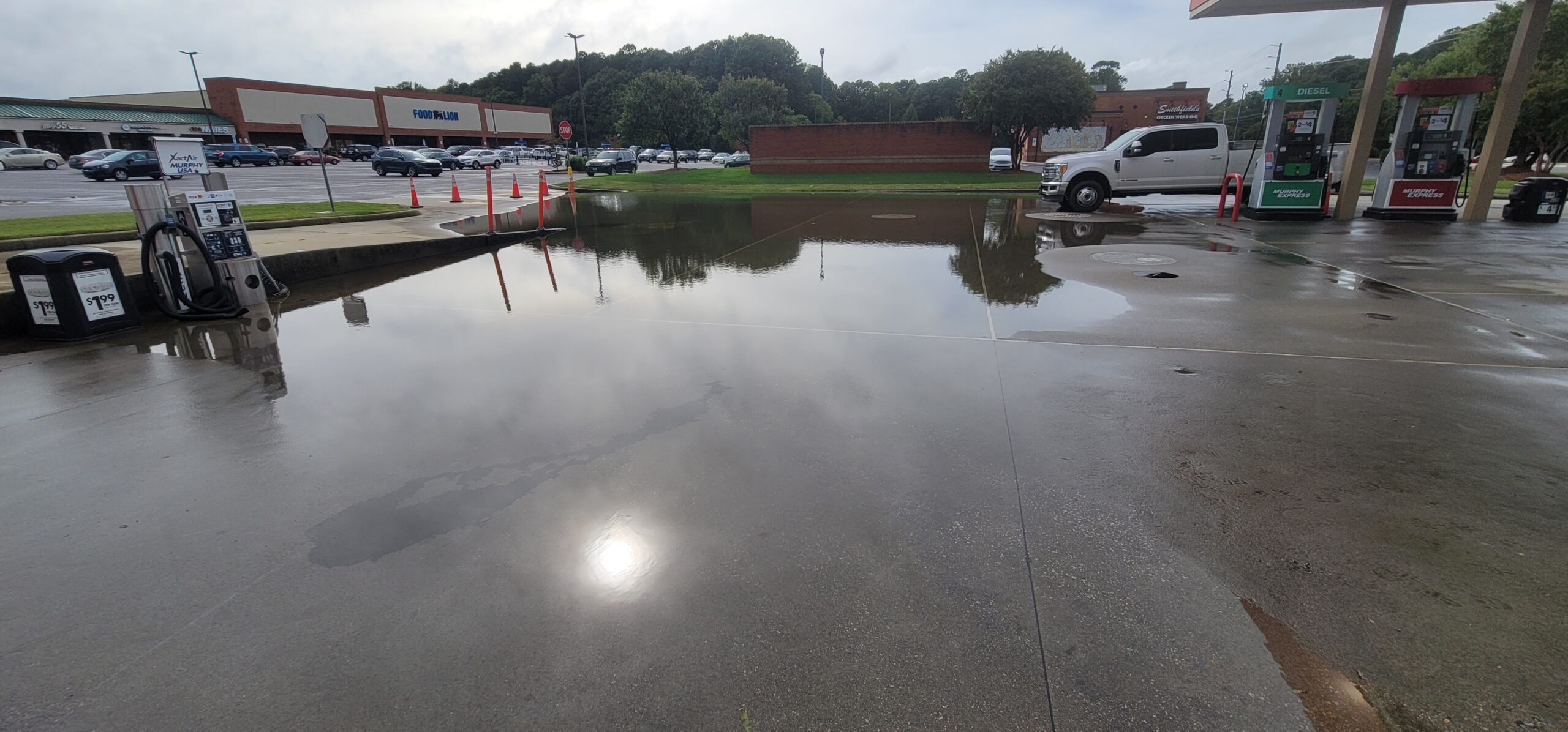 Emergency stormwater response crew addressing flooded drainage system after heavy rainfall