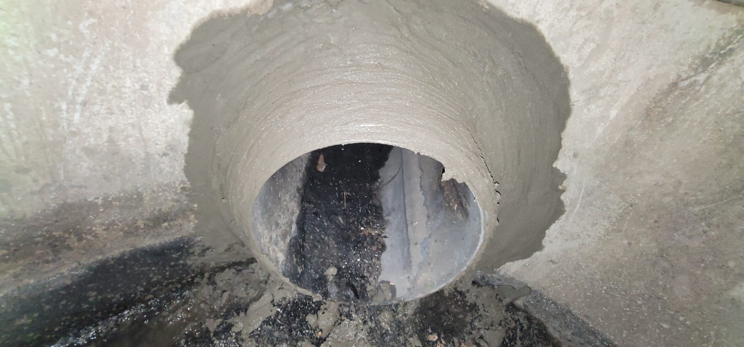 Trenchless stormwater pipe rehabilitation using cured-in-place pipe lining inside damaged drainage system.