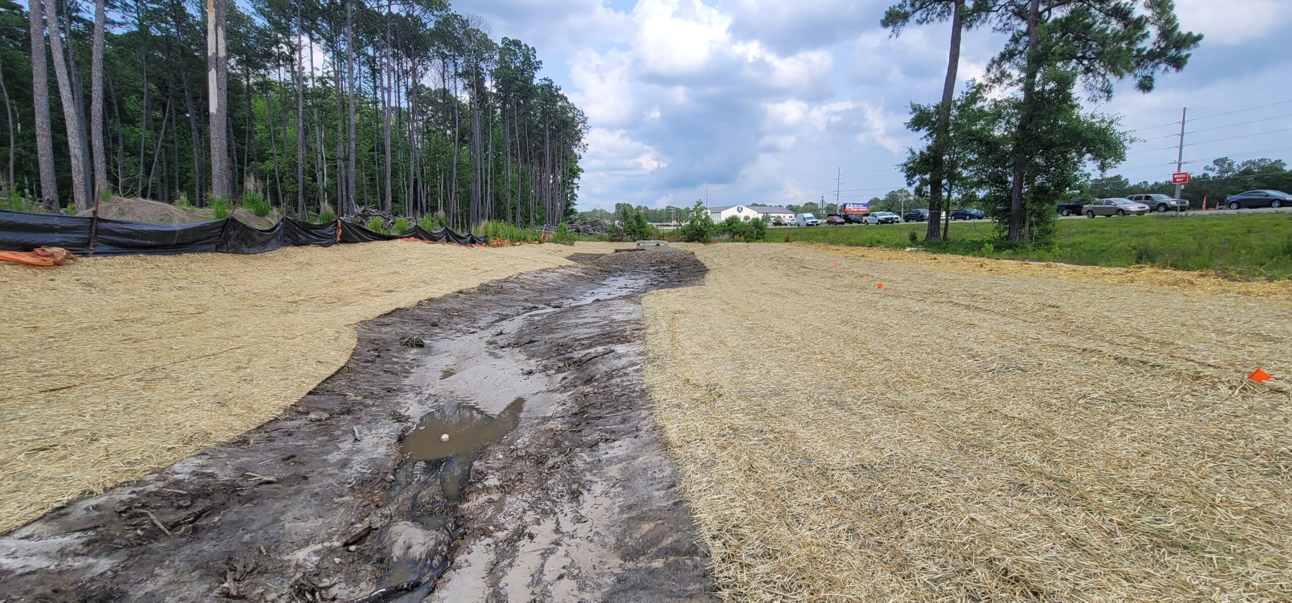 Stormwater infrastructure rehabilitation team repairing a detention pond and storm drain system