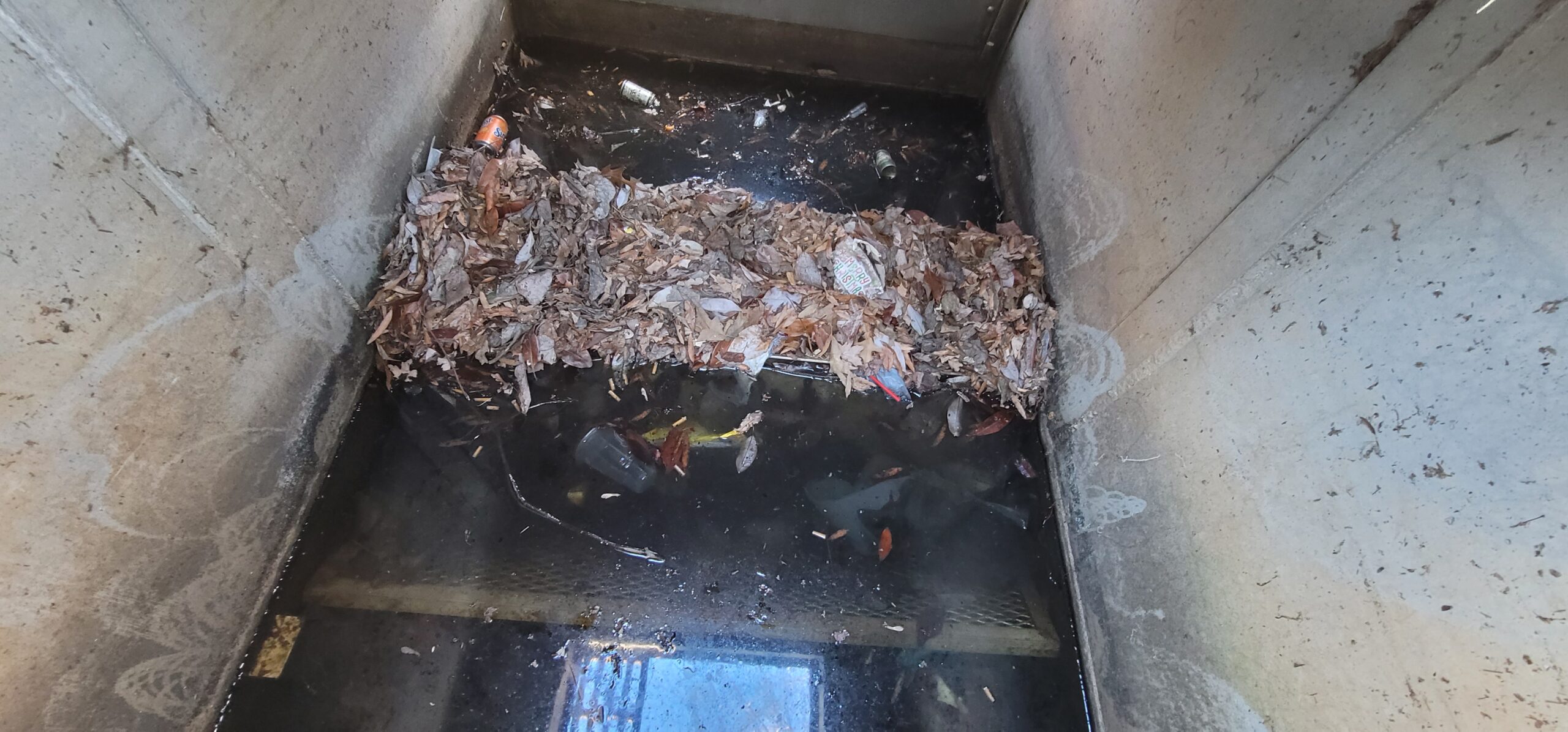 Vactor truck cleaning a trench drain to remove debris and restore proper stormwater flow.