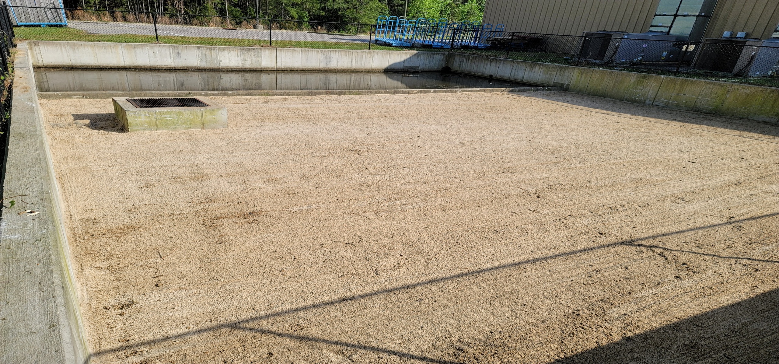 Stormwater sand filter system treating runoff by passing water through a sand media for pollutant removal